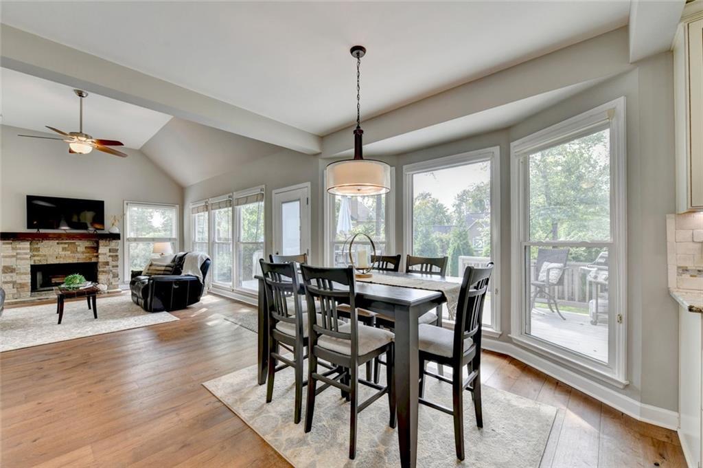 Breakfast area and family room with a stacked stone fireplace